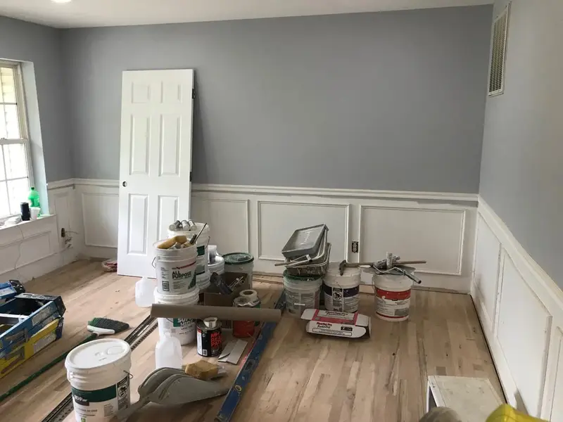 Dining room mid-renovation with new wainscoting and paint cans, Islip, NY